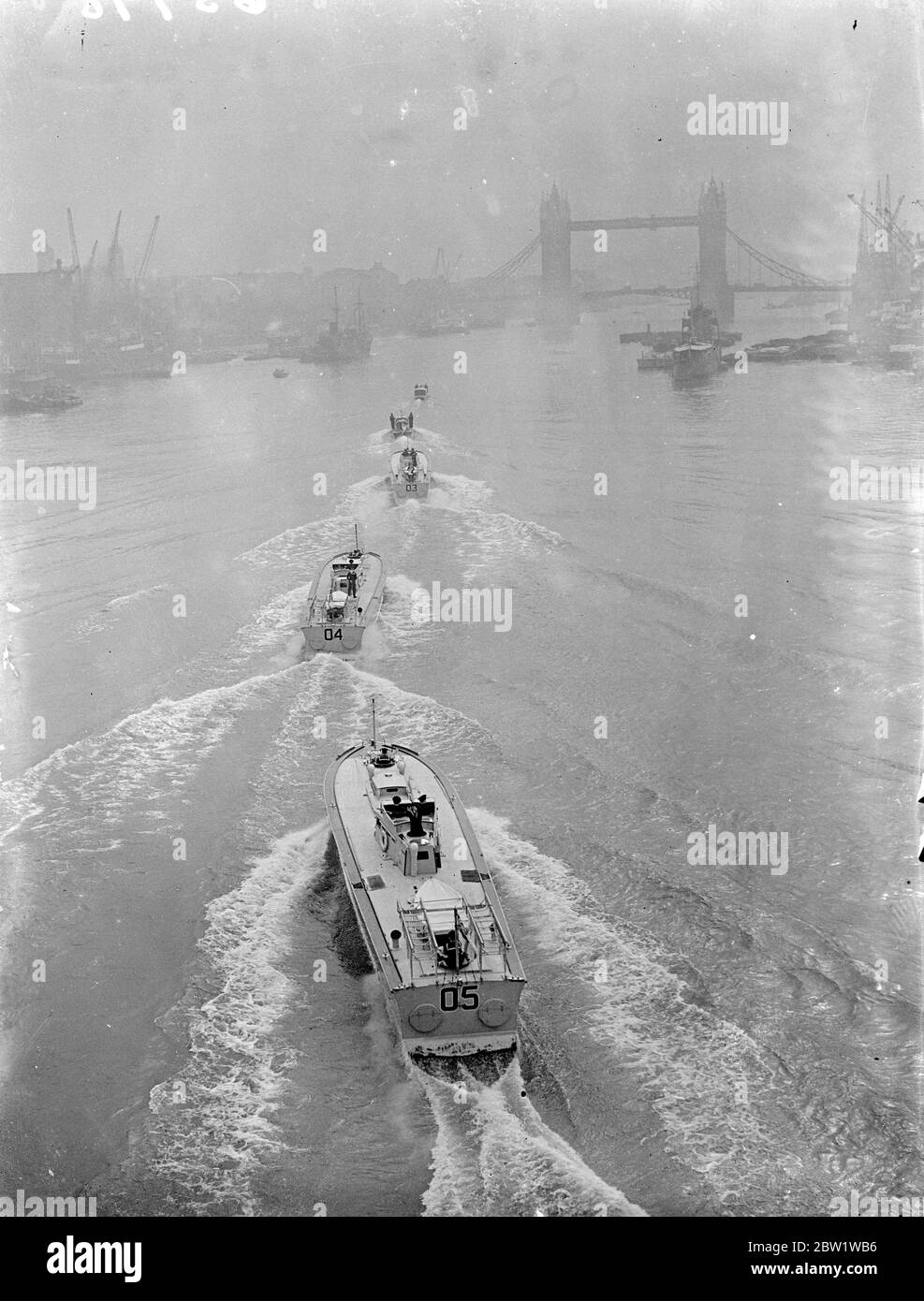Royal barge leads rehearsal of Kings River trip. Rehearsal took place on the Thames for the King's trip from Westminster to Greenwich next Tuesday when he will open the new National Maritime Museum. The Kings barge was in the lead. Photo shows, the Kings barge heading the procession through the Paul of London with Tower Bridge in the background. 24 April 1937 Stock Photo