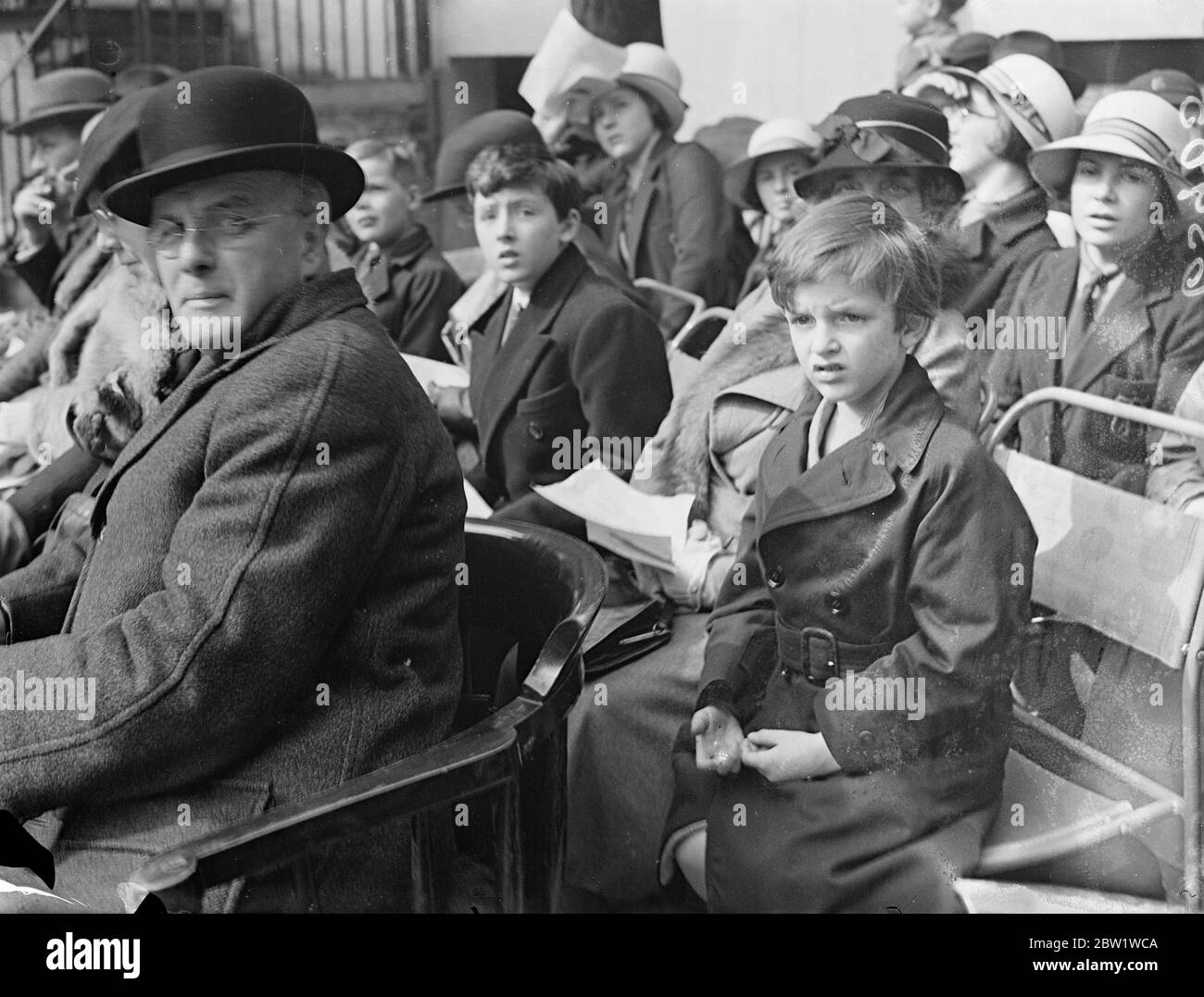 Anthony Eden's sons watch as fire brigade gieves last display at old headquarters. The last display before the brigade's removal to the new building on the Albert Embankment, was given by the London Fire Brigade at the old headquarters in Southwark. Photo shows: the two sons of Mr Anthony Eden - Simon, the eldest and Nicholas - watching the last display. 28 April 1937 Stock Photo