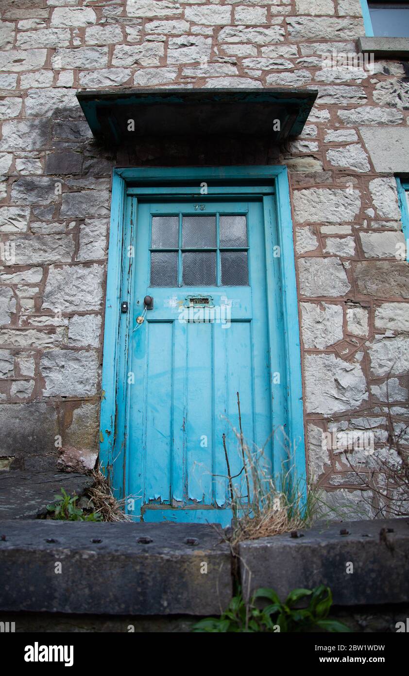 Unkempt / untidy exterior of an empty / disused stonebuilt terraced