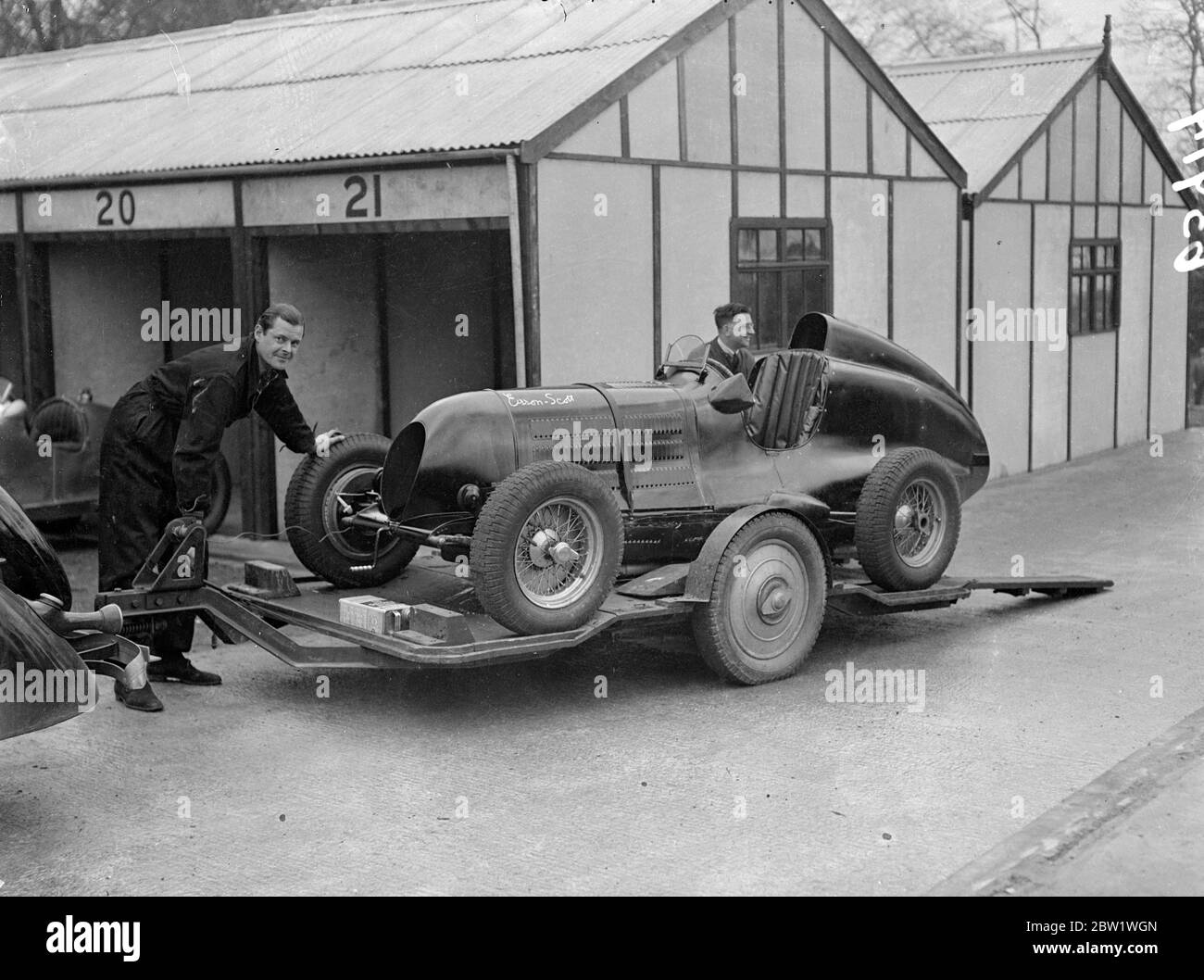 New Crystal Palace road racing track opened. The new road racing track at the Crystal Palace site was opened by Earl Howe, the racing driver. First race on the circuit will be the Coronation Trophy event. Photo shows, A Esson Scott unloading his Scott Bugatti car at the pits. Esses Scott is on left 22 April 1937 Stock Photo