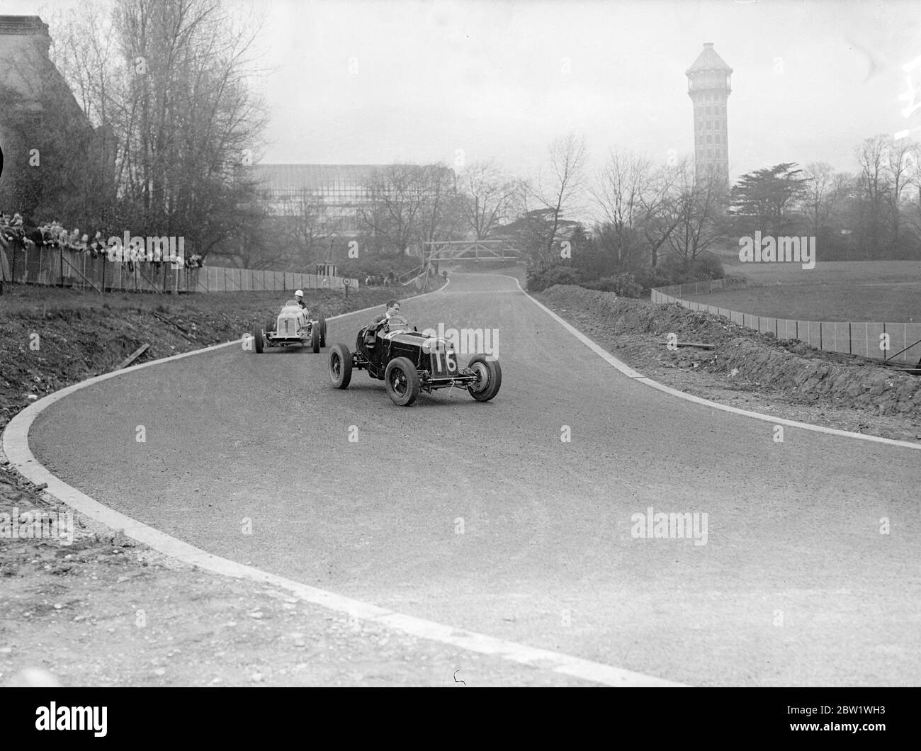 Drivers practice on new Crystal Palace track. Drivers had their first practice on the new Crystal Palace road racing circuit of the opening by Earl Howe. There were two mishaps , H J W Appleton going over the top at Stadium corner and Raymond Mays running of the track owing to wheel locking at the same spot. Photo shows, cars rounding a bend in practice on the new track. 22 April 1937 Stock Photo