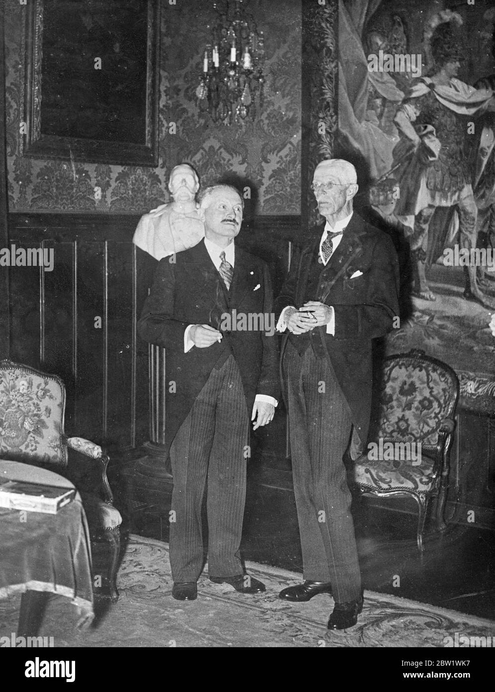 King Gustaf entertains president Lebrun in Paris. King Gustaf of Sweden, in Paris after his holiday on the Cote d'Azur, was the host of President Lebrun of France and members of the French government at a luncheon in the Swedish legation. Photo shows, King Gustav, (right) and president Lebrun conversation at the luncheon . 21 April 1937 Stock Photo