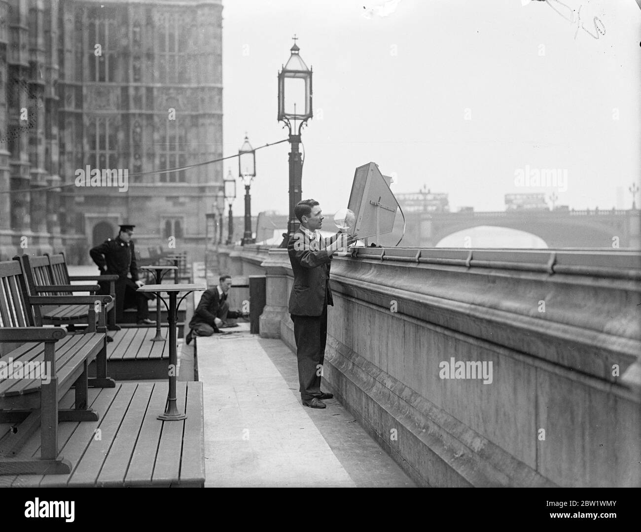 Parliament to be flood lighted for Coronation. Large floodlights are being fixed on the Terrace of the Houses of Commons in preparation for the floodlighting of the Houses of Parliament during the Coronation. Photo shows, fixing one of the floodlights on the Houses of Commons terrace. 14 April 1937 Stock Photo