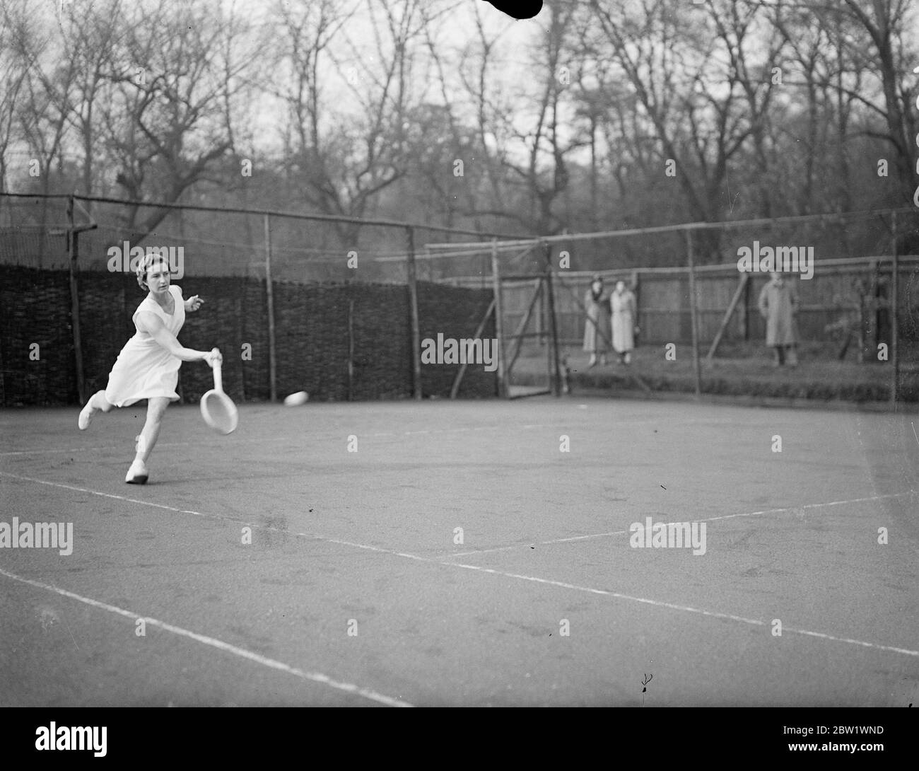Mary Hardwick meets Miss Scriven in Melbury Club semifinals. Miss R M Hardwick met Miss M C Scriven in the semifinals of the Melbury Lawn Tennis Club tournament at the Melbury Club, Kensington. Photo shows, a remarkable action picture of Miss Mary Hardwick in play in the semifinals. 16 April 1937 Stock Photo