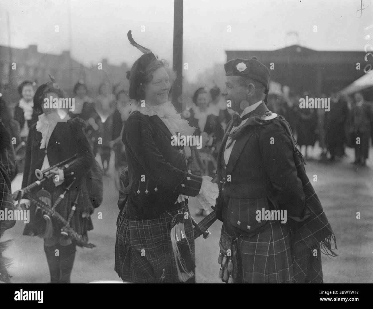 Dagenham Girl Pipers welcomed their new 'Chieftain'. Pipe Maj George Greenfield of the Royal Scots, recognised as one of Scotland's greatest experts on the bagpipes and Highland Dances, was met at Heathway station (District Railway) by the band of the Dagenham Girl Pipers in full uniform when he arrived at Dagenham, Essex, to become Pipe Maj of the Girl Pipers. George Greenfield enlisted in the Royal Scot as a boy piper and has now completed his 21 years service. As 'Chieftain' of the Dagenham Girl Pipers he will be responsible for the piping and dancing instruction of over 50 girls. Photo sho Stock Photo