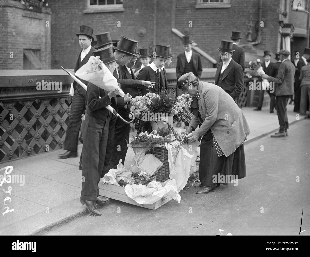 Eton boys buy fourth of June flowers. With a full programme of events, Eton College celebrated 4 June. The Coronation 'Fourth' was expected to be the most brilliant of any post-war year. Photo shows, Eton boys selecting their fourth of June flowers . 4 June 1937 Stock Photo