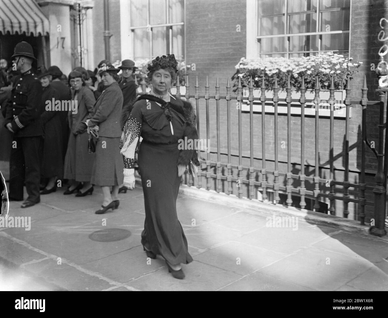 Queen Mary leaves after peers joint golden wedding party. Queen Mary attended the party given by the Duke of Portland at his Mayfair home to celebrate the golden wedding of three of England's most famous peers, the Marquis of Salisbury, the Earl of Kenmare and Lord Desborough, all of whom were his childhood friends. The three peers were married in 1887, Queen Victoria's Jubilee year. Photo shows, Lady Baldwin wife of Sir Stanley Baldwin, leaving after the party. Sir Stanley was invested with the K G at Buckingham Palace this morning (Tuesday).. 1 June 1937 Stock Photo