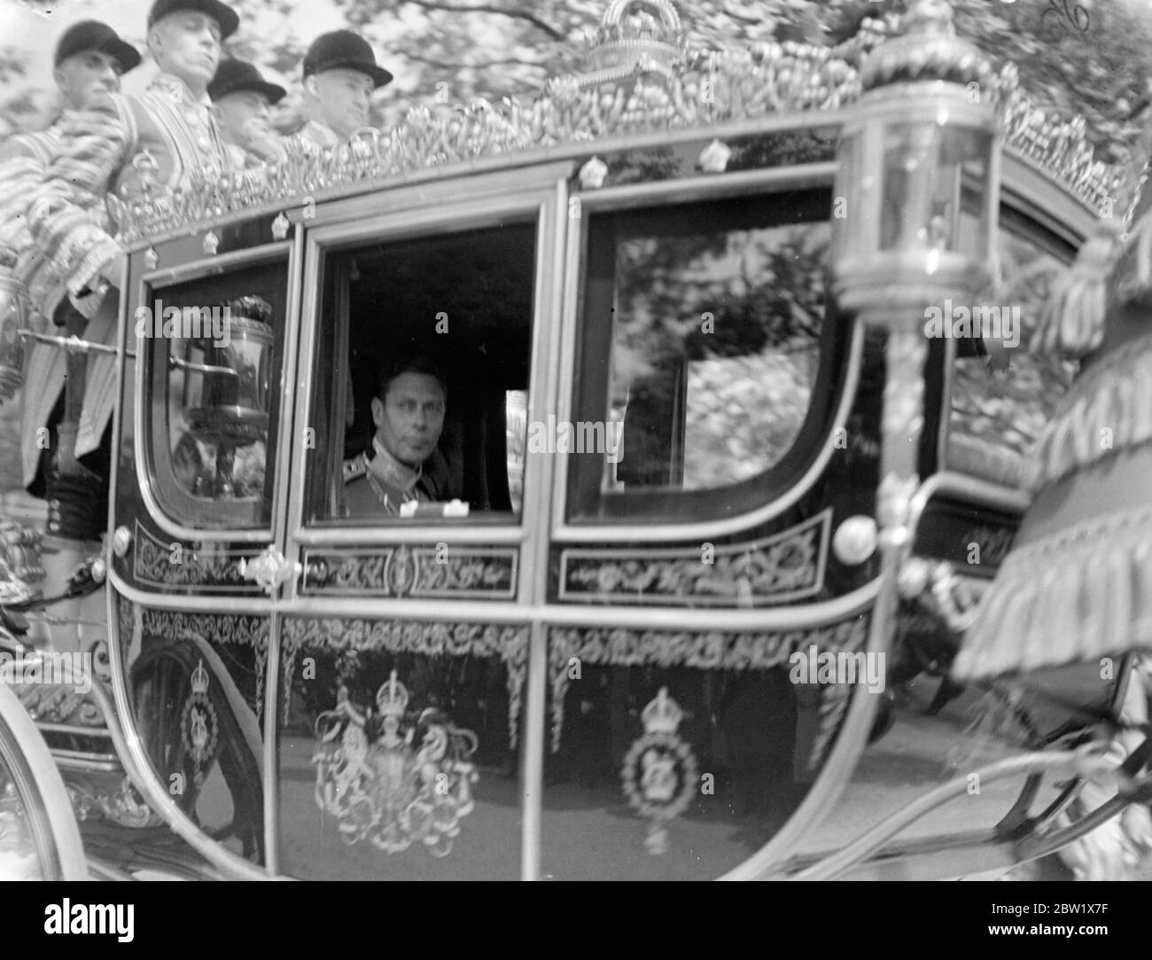 King drives in the State to St James's Palace for Levee. The King drove in State from Buckingham Palace to hold a levee. He was escorted by Household Cavalry and attended by his Gentleman in Waiting. Photo shows, the King in his coach as he drove to St James's Palace. 28 May 1937 Stock Photo