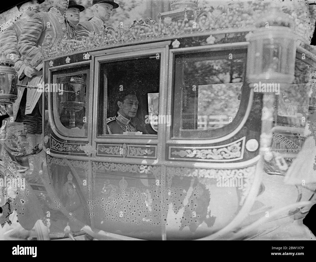 King drives in the State to St James's Palace for Levee. The King drove in State from Buckingham Palace to hold a levee. He was escorted by Household Cavalry and attended by his Gentleman in Waiting. Photo shows, the King in his coach as he drove to St James's Palace. 28 May 1937 Stock Photo