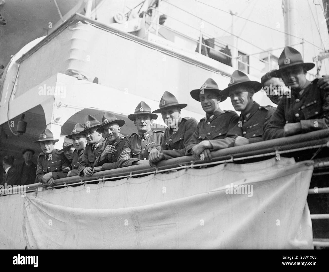 New Zealanders say goodbye to London. Members of the New Zealand Coronation contingent left London for home aboard the Ranigitiki. Ordering their arrangements they travelled by road from Pirbright to the Royal Albert Docks. Photo shows: the New Zealanders take their last look at London from the Ranigitiki. 27 May 1937 Stock Photo