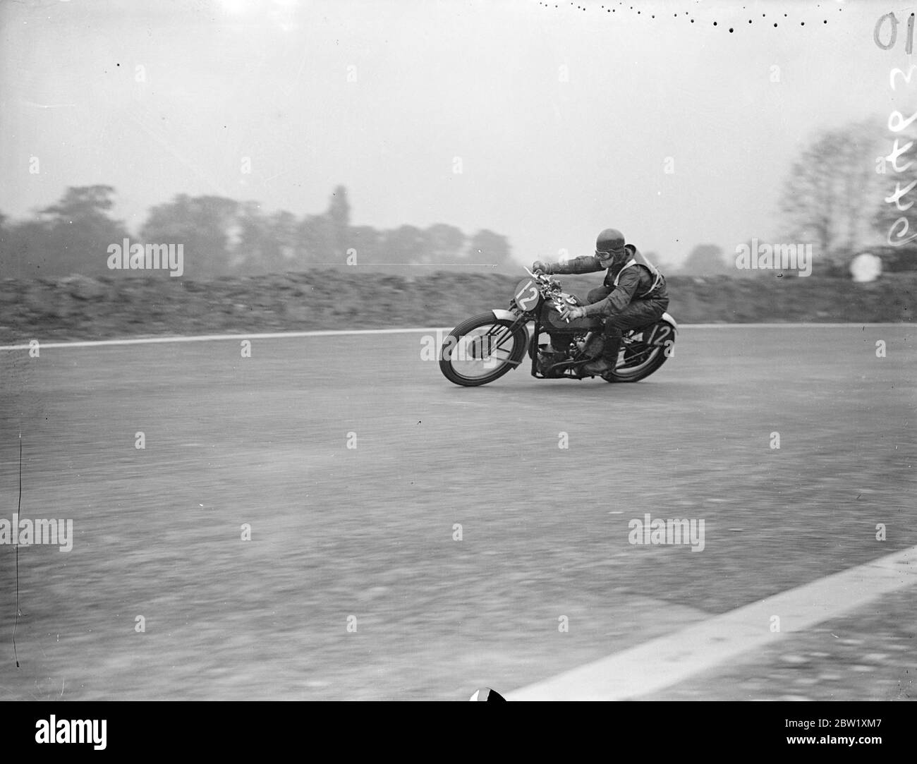 Cann wins Junior Coronation Grand Prix on Crystal Palace circuit. M. Cann (Norton) won the Junior Coronation Grand Prix motor-cycle event on the Crystal Palace road-racing circuit. His speed for the 60 miles course was 53.50 miles an hour. Photo shows: M. Cann rounding Stadium Bend on his Norton. 15 May 1937 Stock Photo
