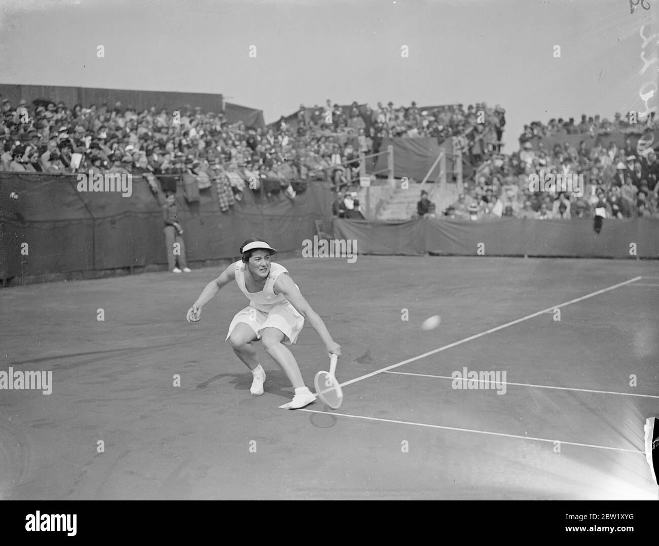 Miss Scriven beats Miss Hardwick in Bournemouth semifinals. Miss Scriven qualified to meet Señorita Lizana in the finals of the Bournemouth hardcourts championships by defeating Miss R M Hardwick 4-6, 6-2, 6-0. Photo shows, Miss Peggy Scriven in play against Miss Mary Hardwick. 30 April 1937 Stock Photo