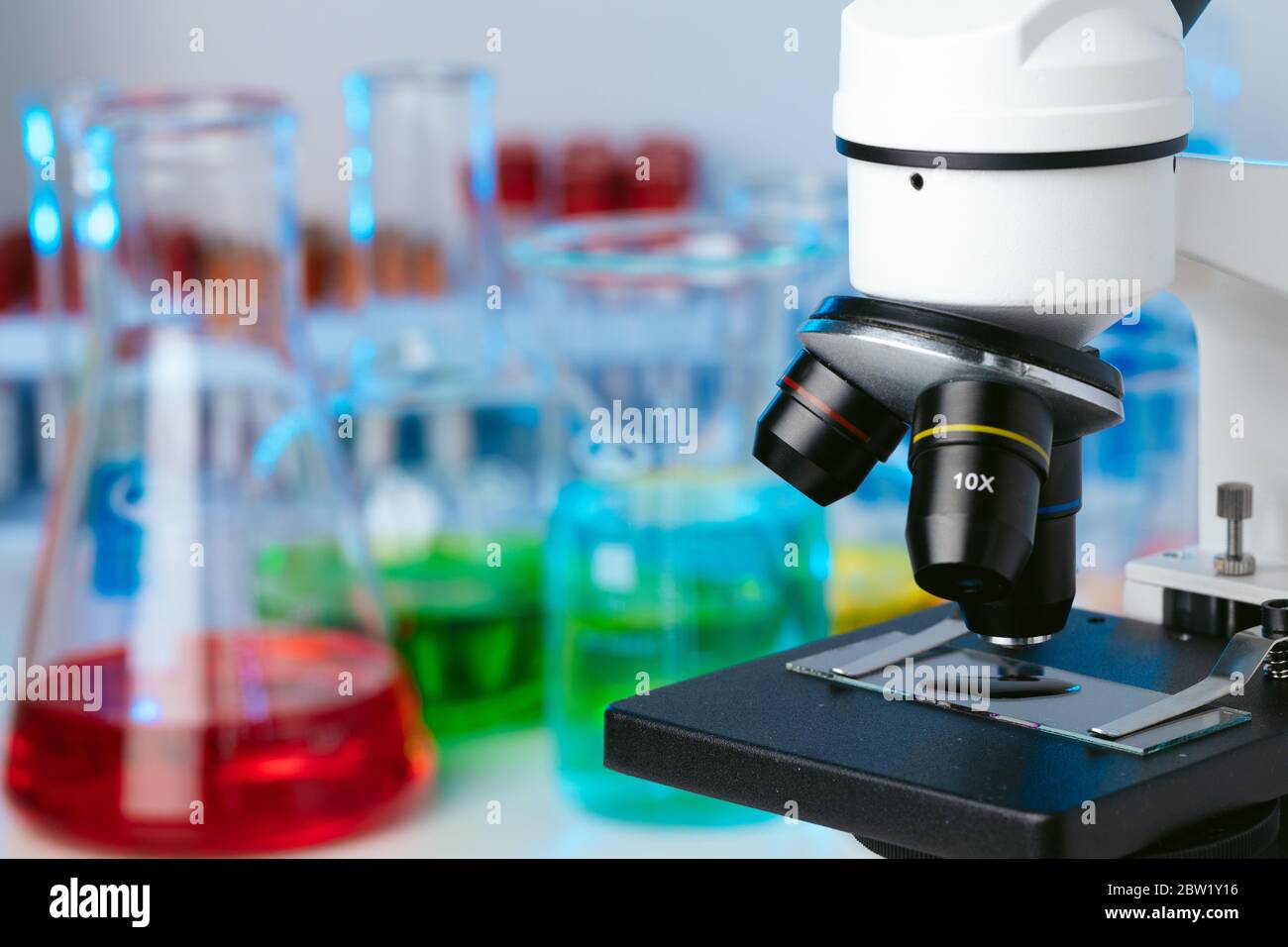 Scientific laboratory with microscope and test tubes with samples ...