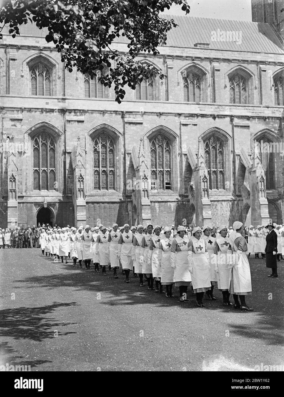 Voluntary Aid Detachments holds Church Parade at Winchester Cathedral. Nurses of the Voluntary Aided Detachment are in summer camp at Sparsholt, Hampshire, attend Church Parade at Winchester Cathedral. The nurses where inspected by Connell F. D. Howell. Photo shows: nurses marching out of the Cathedral. 6 June 1937 Stock Photo
