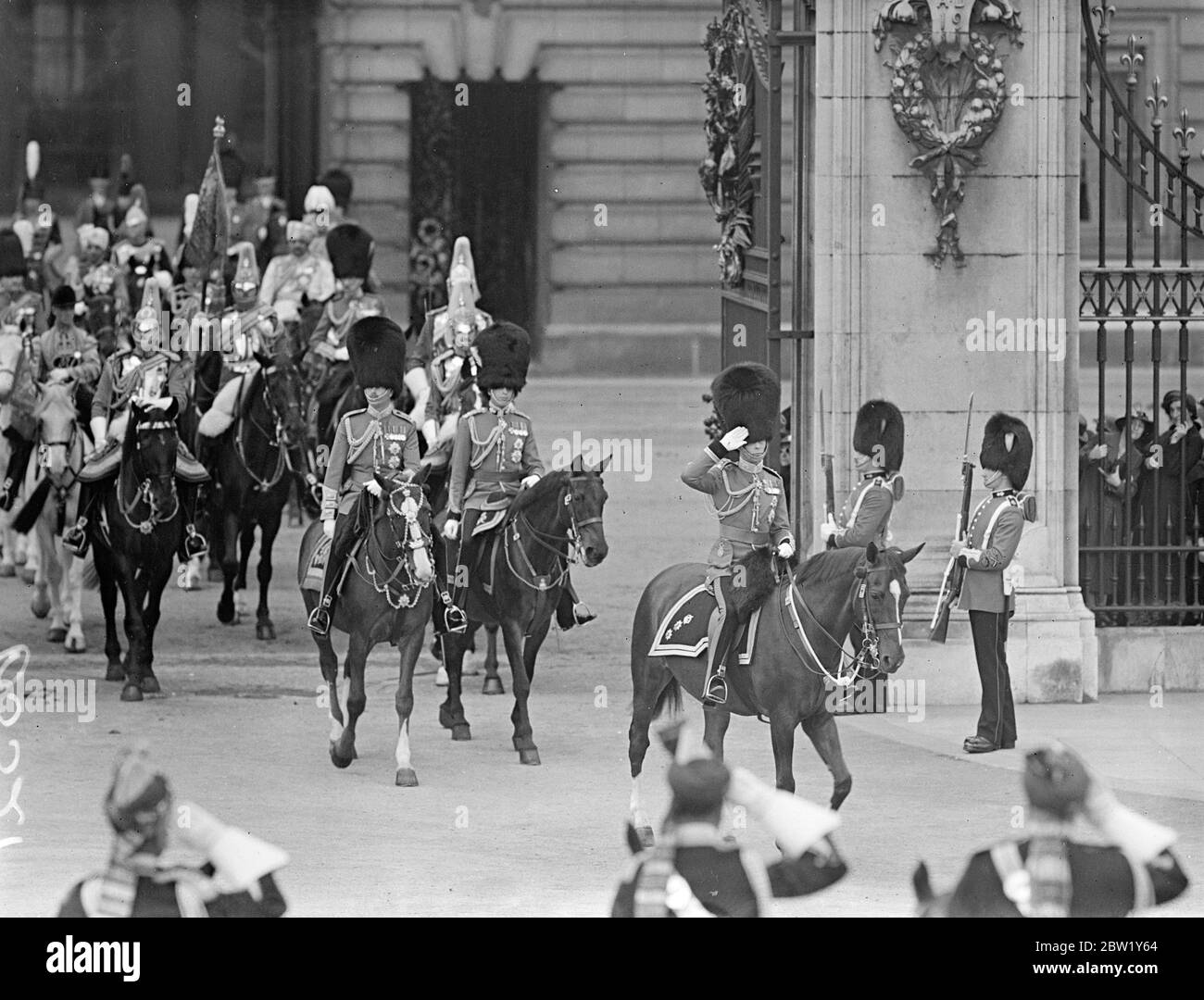 King rides in procession to Horse Guards for Trooping the Colour. The first time since his Ascension. The King Road in procession from Buckingham Palace to attend the ceremony of Trooping the Colour on the Horse Guards Parade. The King was accompanied by the Duke of Gloucester and Kent and Prince Arthur of Connaught. Photo shows, the King, followed by the Royal troops and Prince Arthur of Connaught is the procession left at Buckingham Palace. 9 June 1937 Stock Photo