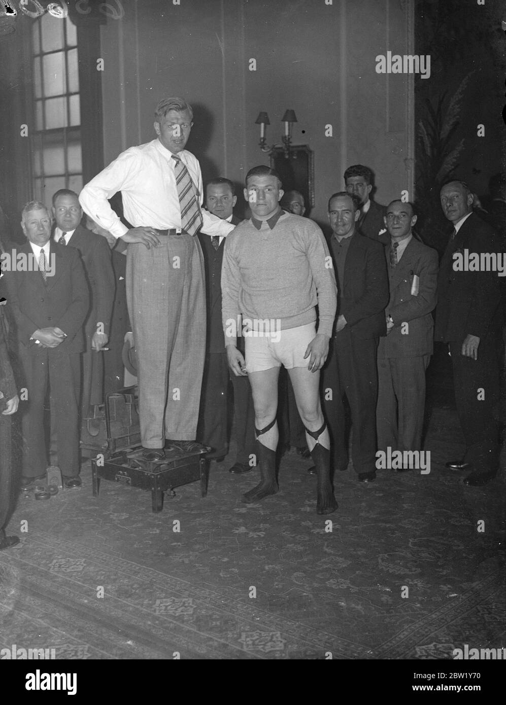 Neusel and Farr weigh-in at Stadium Club. Walter Neusel, the German heavyweight and Tommy Farr, conqueror of Max Baer, weighed in at the Stadium Club, Holborn, for their fight at Harringay tonight (Tuesday). Photo shows: Walter Neusel (on the scales) and Tommy Farr at the weigh-in. 15 June 1937 Stock Photo