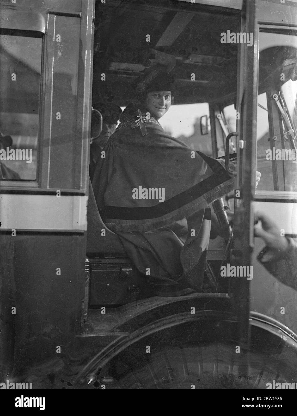 Woman Mayor of West Ham drives first trolleybus - biggest change-over begins Sunday morning. Mrs Daisy Parsons, Mayor of West Ham, drove a trolleybus out of the Greengate Street depot, West Ham, early Sunday morning to inaugurate London Transport's largest conversion from tramcars to trolleybuses. More than 15 road miles are affected. 78 trams will be withdrawn and 85 trolleybuses will replace them. They are said to be the quietest passenger vehicles yet devised. Photo shows: Mrs Daisy Parsons, Mayor of West Ham, in the driving seat of the first trolleybus. 6 June 1937 Stock Photo