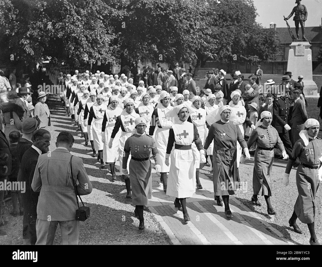 Voluntary Aid Detachments holds Church Parade at Winchester Cathedral. Nurses of the Voluntary Aided Detachment are in summer camp at Sparsholt, Hampshire, attend Church Parade at Winchester Cathedral. The nurses where inspected by Connell F. D. Howell. Photo shows: Nurses marching out of the Cathedral. 6 June 1937 Stock Photo