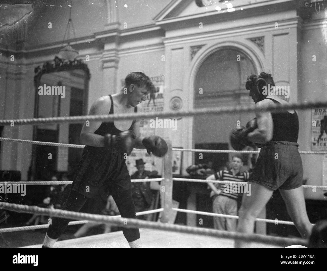 Tommy Farr trains for match with Walterl Neusel. Tommy Farr, the Welsh heavyweight, conqueror of Max Baer, is training at the Point House, Blackheath, London, for his fight with a Walter Neusel, the German boxer, at the Haringay Arena, London, on 15 June. Photo shows, Tommy Farr (left) in a training bout with a sparring partner at his Blackheath gymnasium. 9 June 1937 Stock Photo