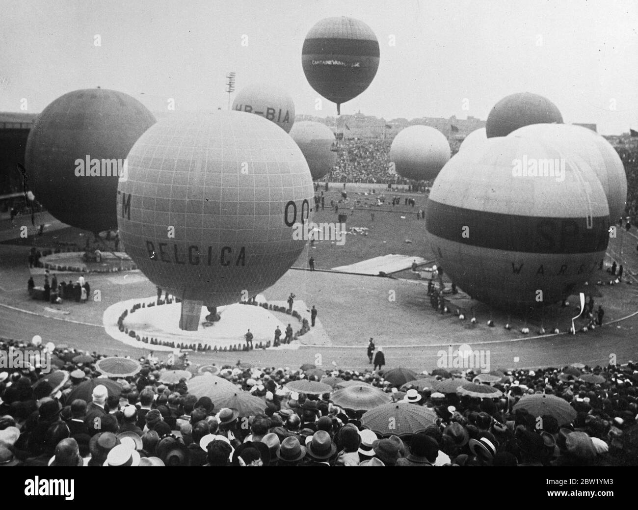 Balloons start from Brussels in Gordon Bennett race. Balloonists started from the Heysel Stadium, Brussels, in the annual Gordon Bennett balloon race. This year's event is the 25th of the series. Photo shows, at the start of the race with the balloons about to ascend. 21 June 1937 Stock Photo