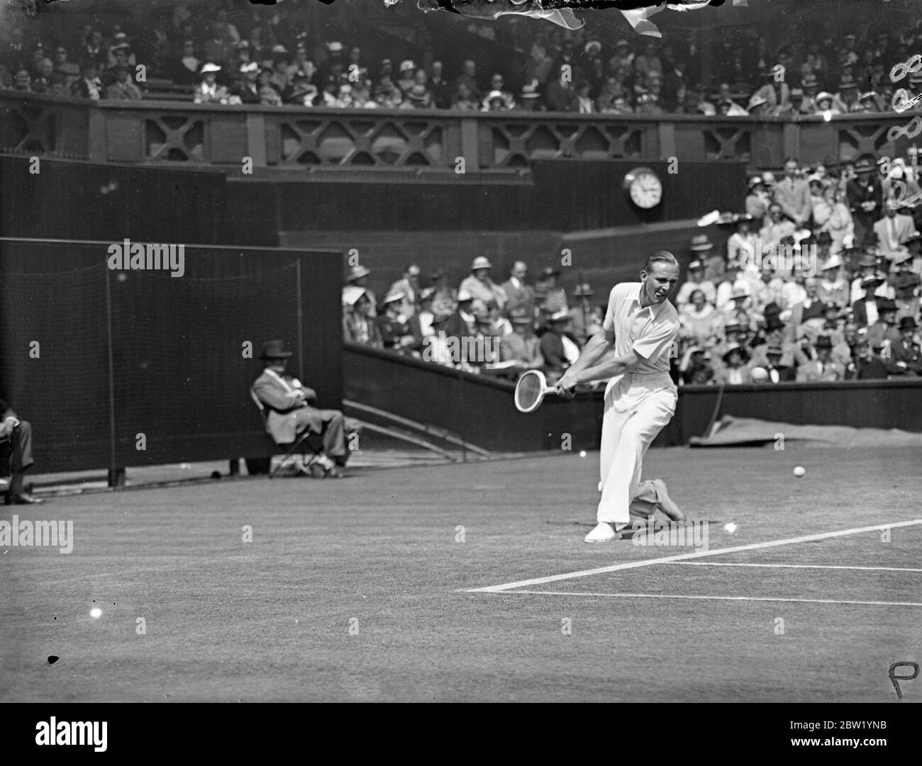 Double handed play at Wimbledon, Australian style in singles match. J Bromwich, the Australian player, makes a double handed stroke during his match on the Centre Court with V G Kirby, the South African, in the men's singles of the all England Championships at Wimbledon. 23 June 1937 Stock Photo