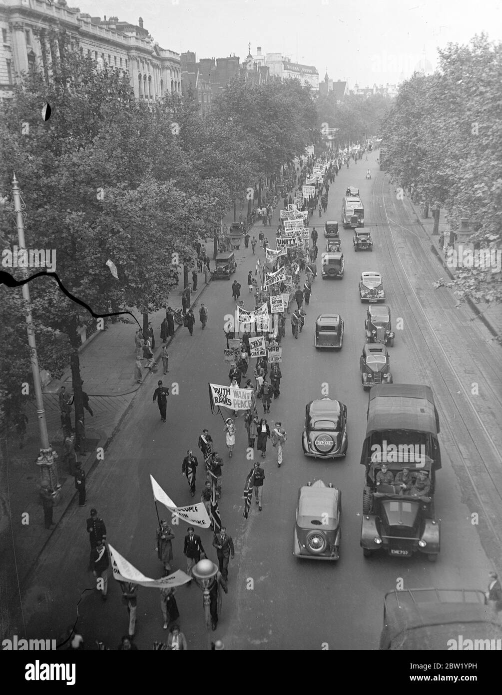 2000 rally in pageant of pace. March to Hyde Park. 2000 members of British youth organisation, wearing the national costumes of peaceloving countries. Took part in the gigantic pageant of peace rally to Hyde Park. Photo shows, the procession, led by girls in Czechoslovakian national costume, passing down Victoria embankment to Hyde Park. Photographs of Lenin are carried in the procession. 20 June 1937 Stock Photo