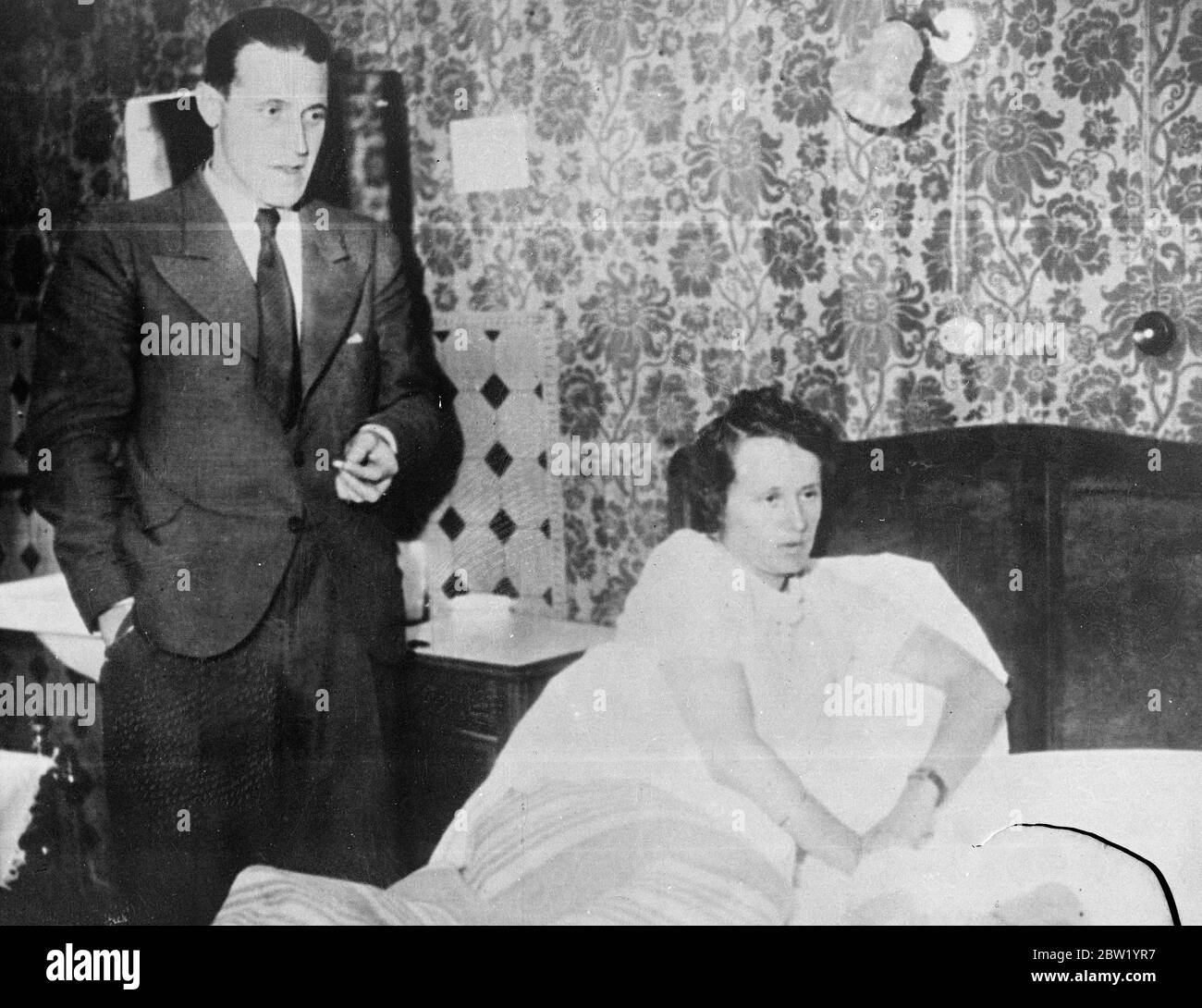 German girl at Paris Exposition ordered home after romance with a Swiss man. FrÃ¤ulein Herta Rost, aged 27, lying in bed in distress after she has been ordered to return at once to Berlin because the pavilion directors do not approve of her romance with a young Swiss businessman .With her is her Swiss fiance, Jan Bopp who has been questioned by Paris police and said he would marry her as soon as possible to give her Swiss nationality. 18 June 1937 Stock Photo