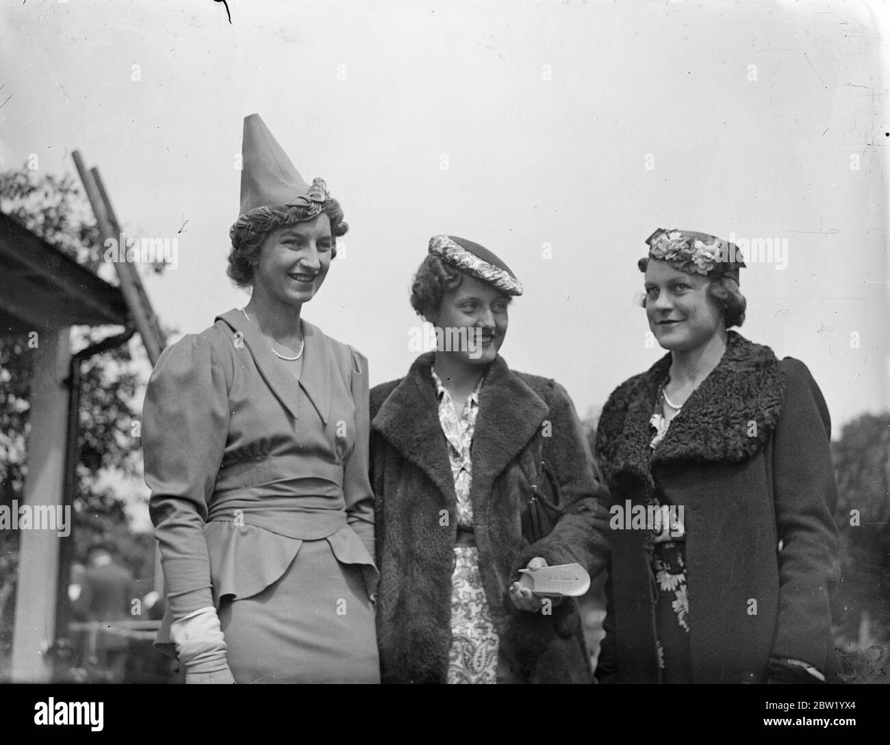 Contrasting hat fashions at free Wimbledon reception. Three of the original and contrasting hat fashions worn by players attending the special reception given at Roehampton club to competitors in the Wimbledon Championships, opening tomorrow (Monday). Left-to-right, Miss Mary Hardwick, Miss Wittenstrom (Sweden) and Miss Heeley. 20 June 1937 Stock Photo