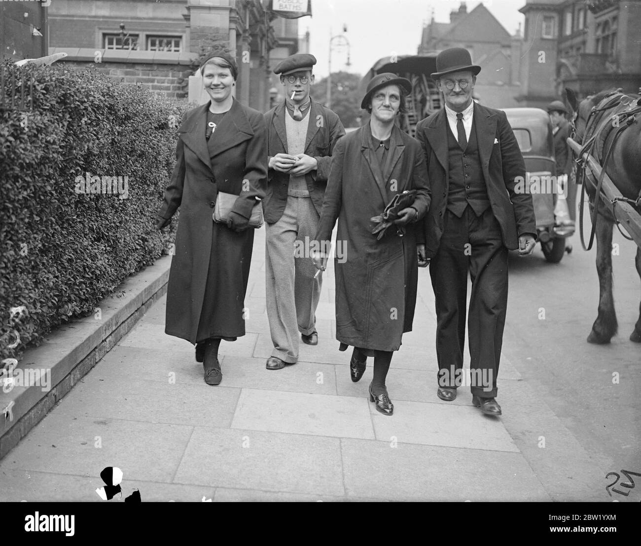 Man was arrested after the body of Daisy Vera Skeels, a 16-year-old waitress has been exhumed, for an inquest. Andrew Chumley was taken into custody on the coroners warrant on the charge of manslaughter. Photo shows: the parents of the victim Mr and Mrs William Skeels and their daughter, Edith with partner Leslie Hughes leaving after giving evidence at the inquest at Hounslow, London. 18 June 1937 Stock Photo