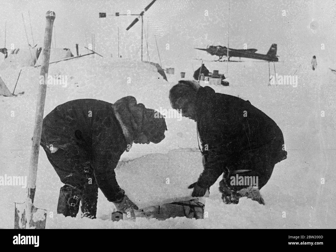 Members of the Soviet polar expedition taking the first water test from the Arctic Ocean. The Russian scientists are conquering the legendary land of ice and snow on top of the world that is still uncharted. They have settle down for a year's stay on an ice floe at the North Pole and are now making whether surveys. 9 July 1937 Stock Photo