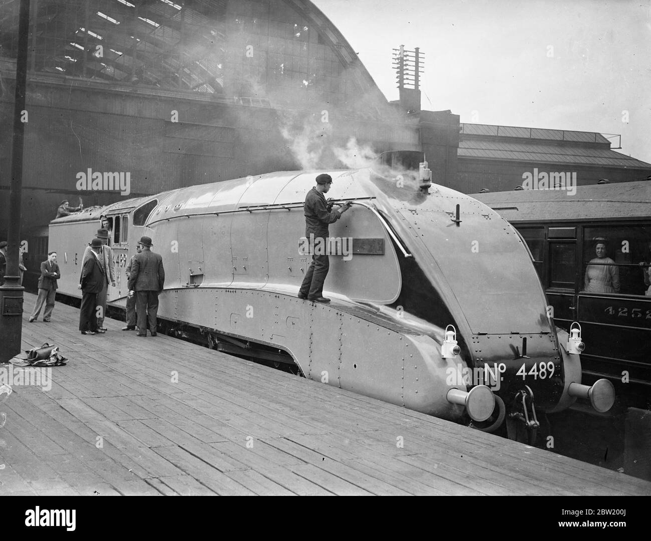 Empire's fastest streamlined train arrives at King's Cross. The first of the L. N. E. R.'s special streamlined engines, built for the Coronation streamlined express to run between King's Cross and Edinburgh, arrived at King's Cross Station to be named Dominion of Canada by the High Commissioner for Canada, the Hon. Vincent Massey. The down train, on its run between London and York, will be the fastest train in the British Empire, averaging 71.9 mph for 188 miles. Dominion of Canada, which was built at Doncaster, has been fitted with a special chimney whistle similar to those in use on the mamm Stock Photo