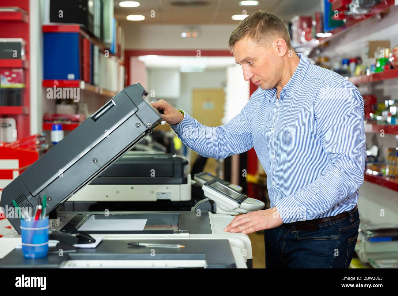 Worker is printing a file, document in the office room Stock Photo