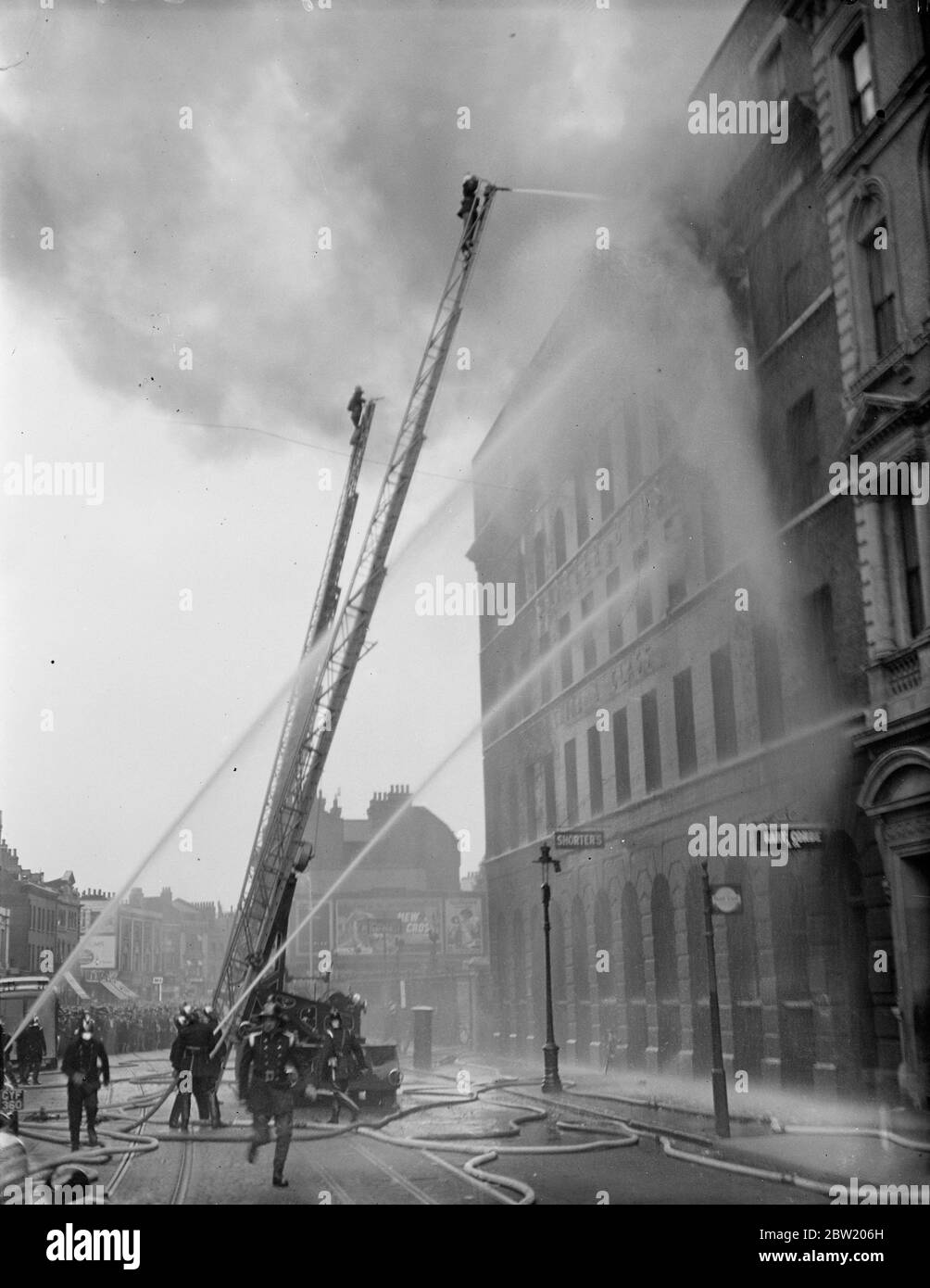 Fire involving all the four floors of a Elephant and Castle china warehouse of the Messrs. Shorter Bros, broke out during the rush-hour. The fire brigade call was circulated and extra police were called in to cope with the traffic and crowds. 18 June 1937 Stock Photo