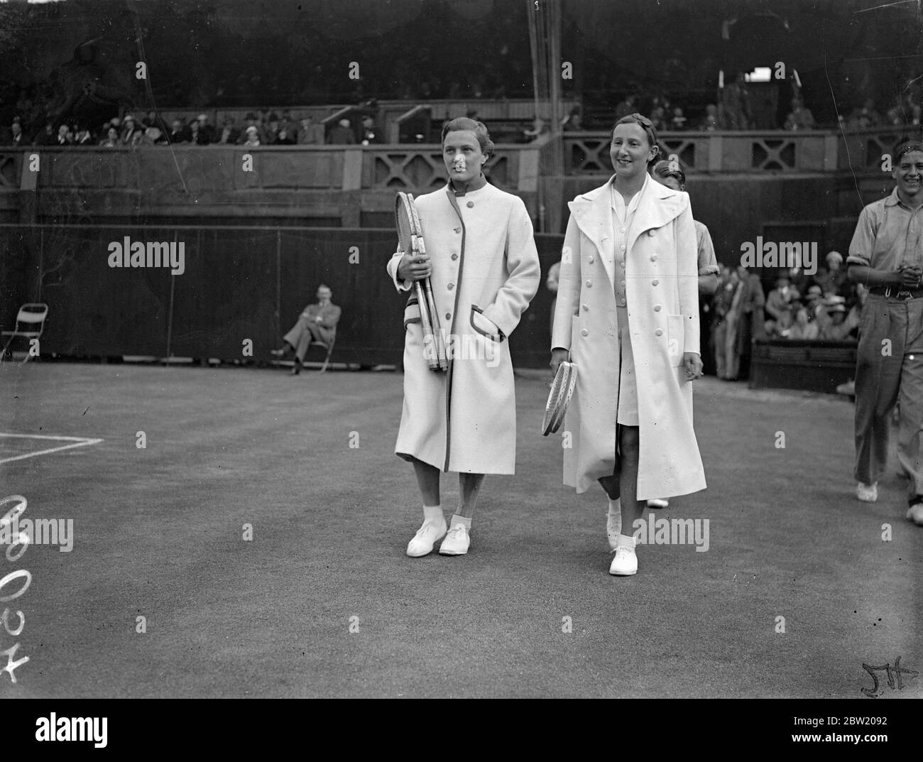 Miss Dorothy Round of Great Britain, defeated Miss Helen Jacobs, the champion, 6-4, 6-2 in the women's singles at Wimbledon. Miss Dorothy Round and Miss Helen Jacobs walking onto the Centre Court for their match. 29 June 1937 Stock Photo