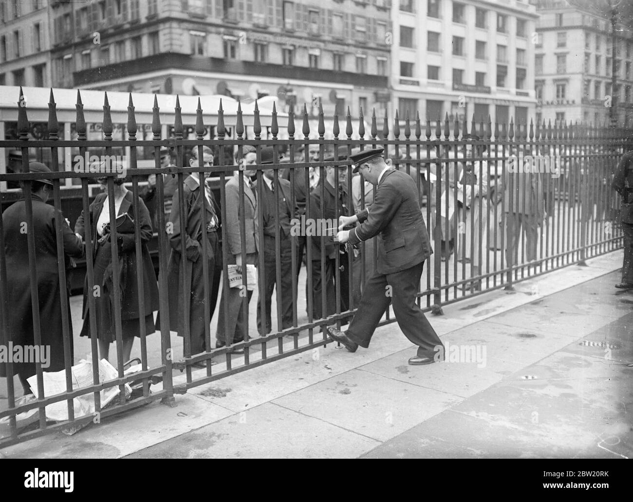 To prevent speculation while measures for dealing with the financial crisis a rush through the chamber, the French Government has ordered the closing of the Paris Bourse until further notice. The new Finance Minister made a dash from America, is preparing secret measures to solve the crisis. Shutting the gates of the Bourse in Paris. 29 June 1937 Stock Photo