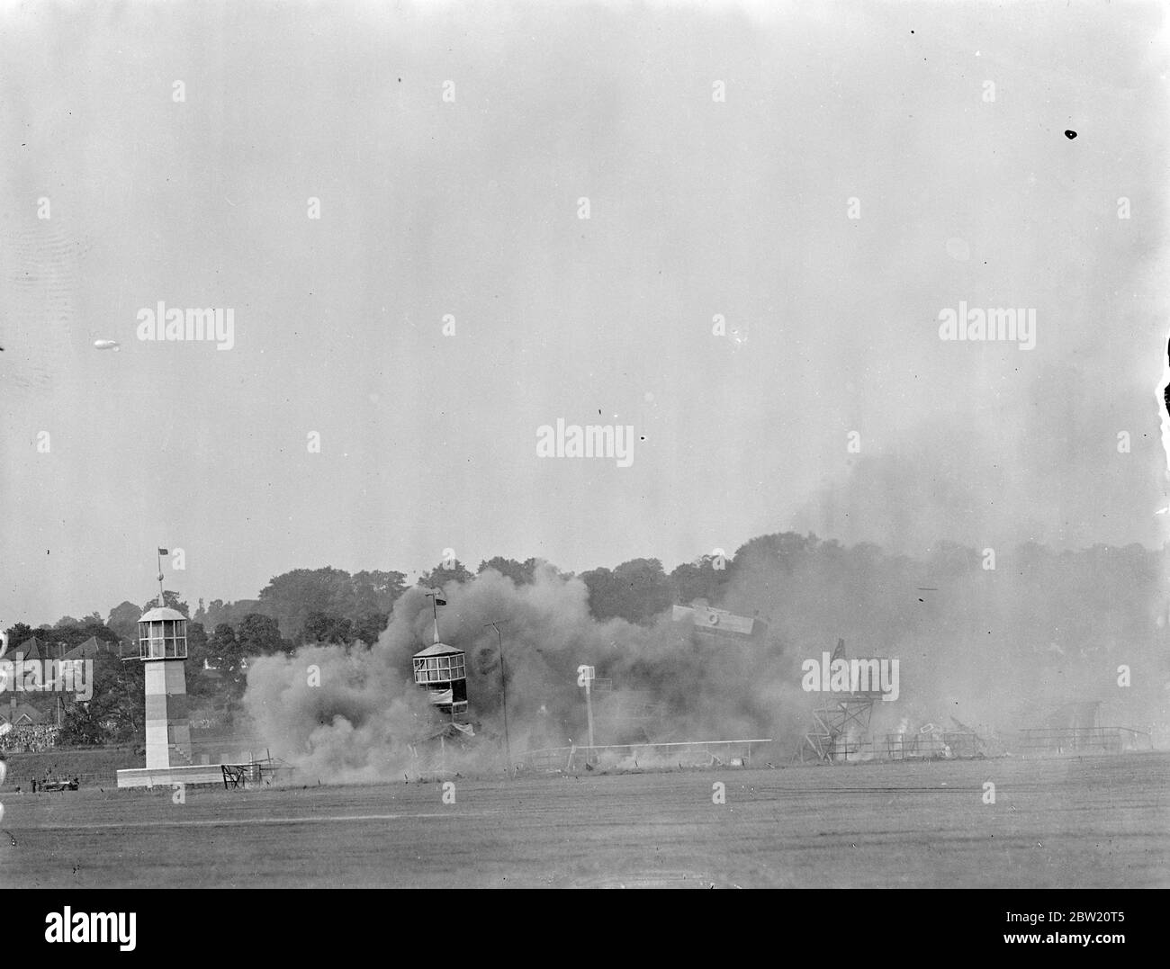 Smoke raising from the port which has been attacked by bombers and torpedo bombers, mimicking air battle at the annual Royal Air Force Pageant at Hendon Aerodrome. 24 June 1937 Stock Photo