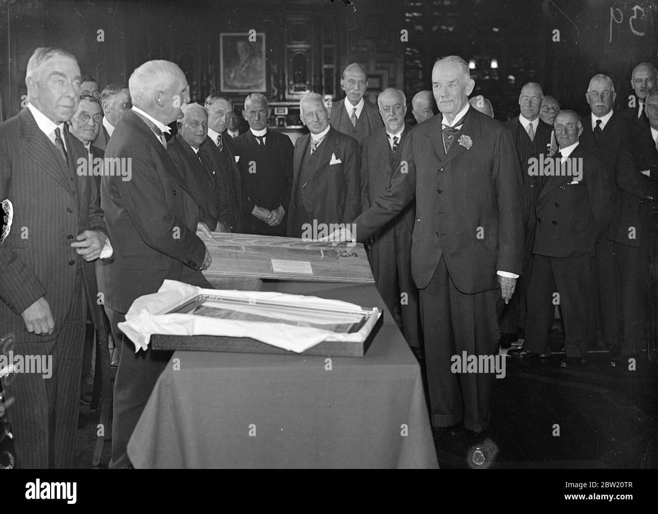 Lord Desborough, who is retiring after 41 years service Chairman of the teams Conservancy Board, was presented with a sword, said to date from 800 BC recovered from the bottom of the Thames at the Board's office on the Embankment. Lord Desborough (right) receiving the sword from Mr B. Holmes. 12 July 1937 Stock Photo