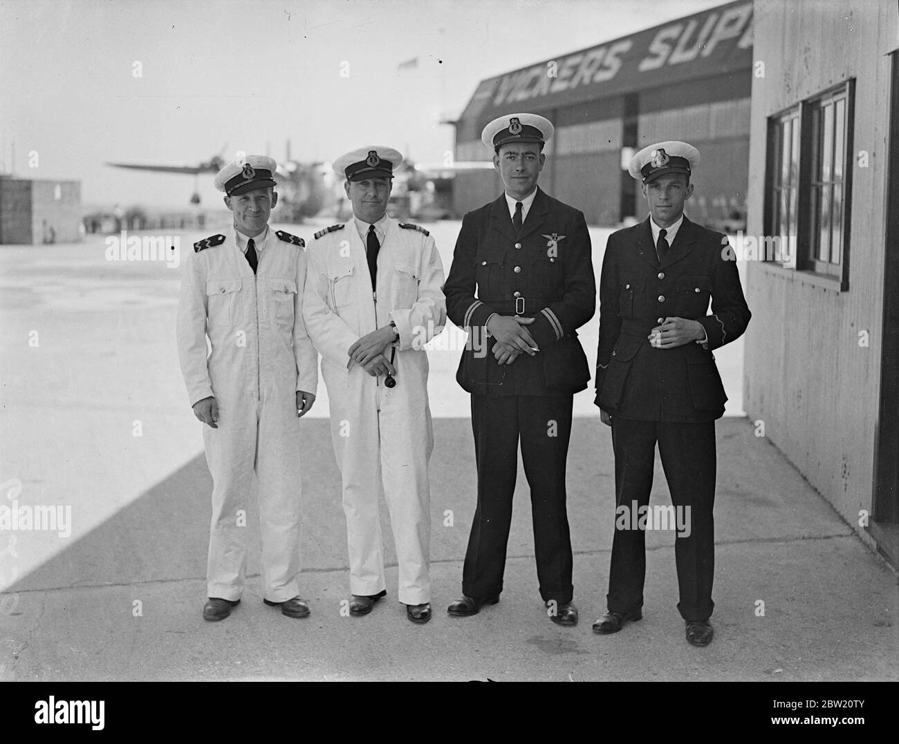 'Caledonia' crew for first experimental transatlantic flight. Captain A S Wilcockson, commander, and the crew of the giant Empire flying boat 'Caledonia'photographed at Southampton before leaving for the Shannon base in the Irish Free State from where the 'Caledonia'will take off on her first experimental transatlantic flight to Newfoundland and New York. Left to right, radio operator Hobbs, Captain A S Wilcockson, First Officer Bowes, and radio operator Lewis. 4 July 1937 Stock Photo