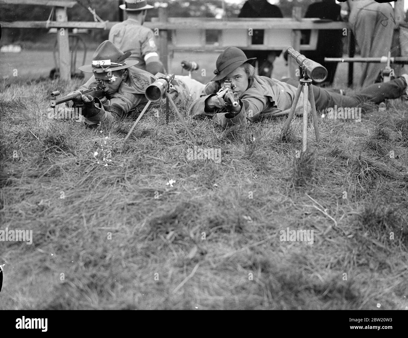 Great Britain retains the Pershing Cup by defeating the American small-bore rifle team at Bisley, Surrey. The match was the first that has taken place since general Pershing presented the Cup in 1931 when Britain won the trophy. Mr and Mrs W. D. Woodring of America, shooting in the small -bore competition at Bisley, Surrey. Mrs Woodring is leading in the ladies championships. 10 July 1937 Stock Photo
