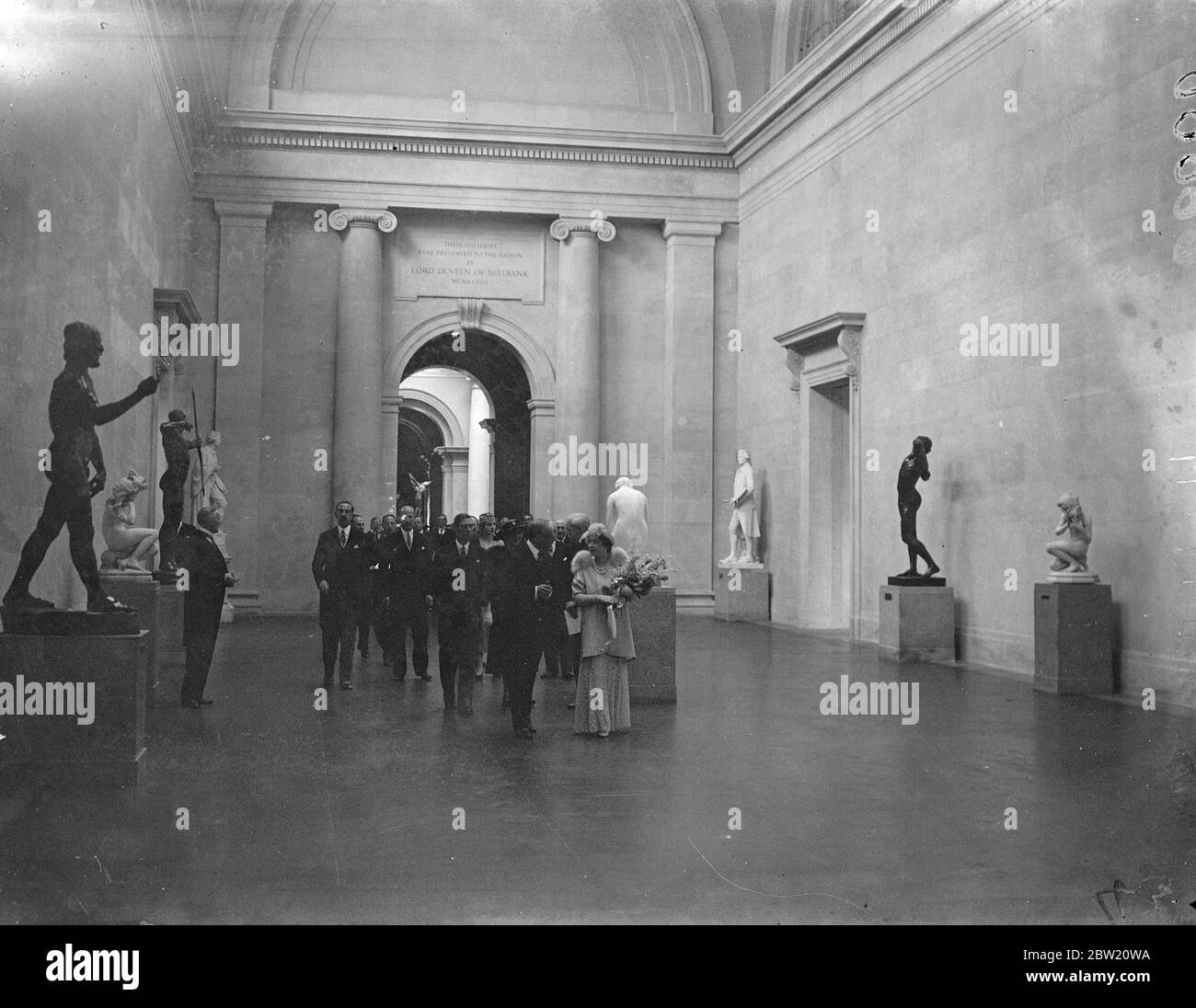 The new Tate Gallery which the King and Queen opened today (Tuesday). The sculpture gallery which was presented by Lord Duveen, gives an architectural vista nearly 500 feet long and is the greatest hall of sculpture in the world. The King and Queen inspecting the new sculpture hall. 29 June 1937 Stock Photo