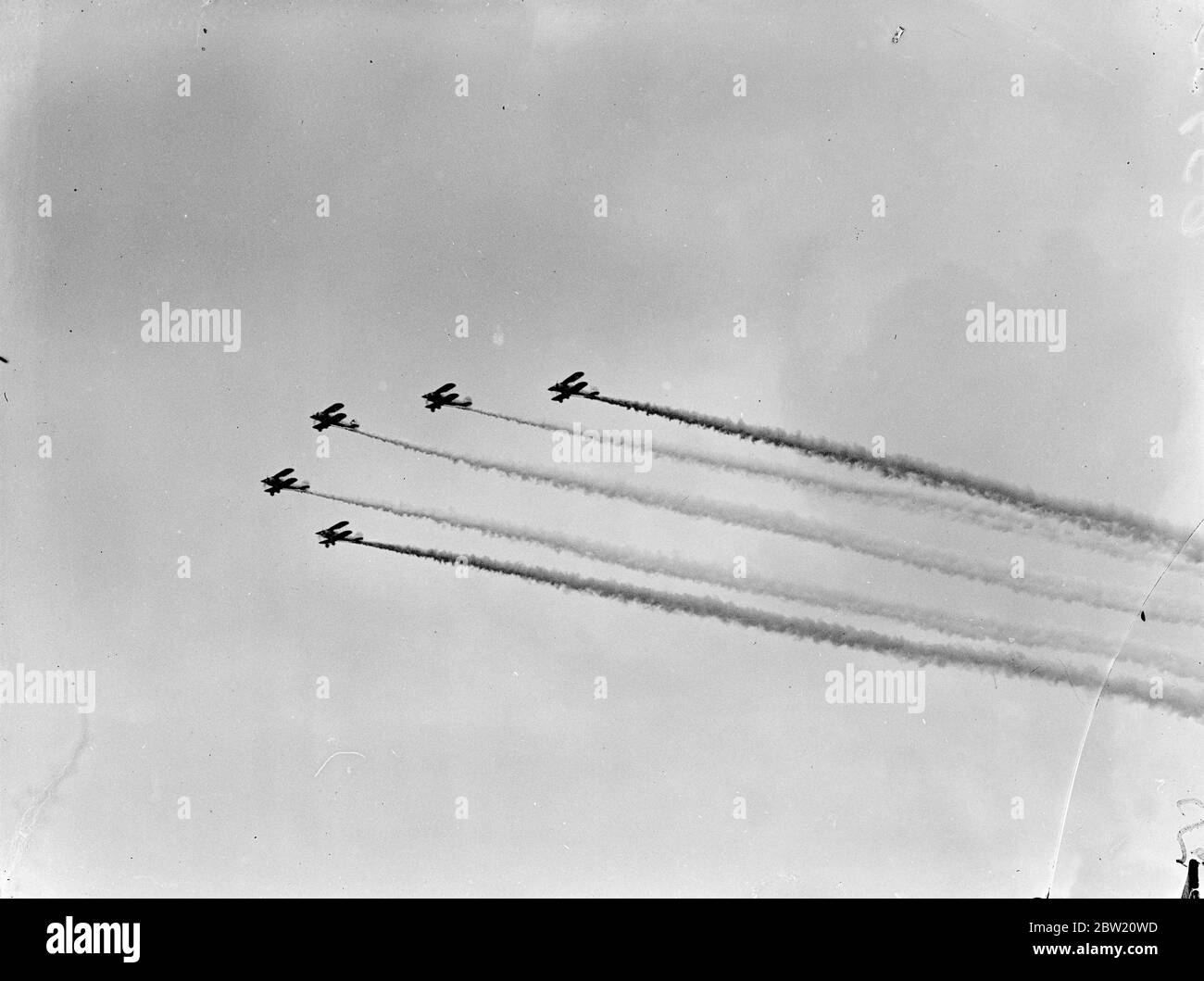 Royal Airforce Bristol Bulldog fighter planes fly in formation during a smoke display. Stock Photo