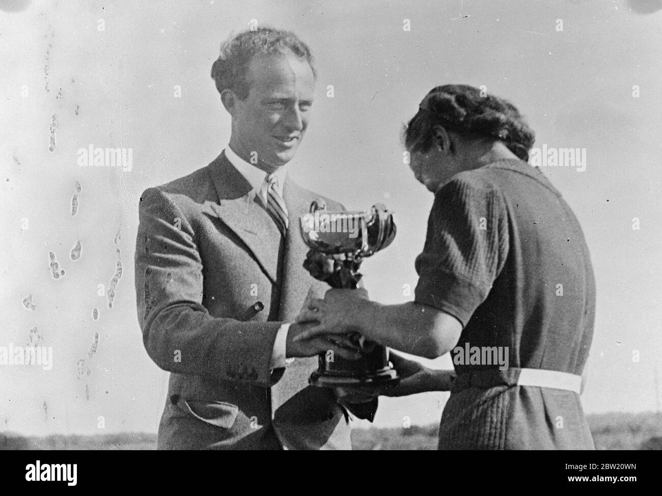King Leopold of the Belgians presented the King's Cup to Madame May, winner of competition for Belgian women golfers at Zoute Golf Club. 20 July 1937 Stock Photo