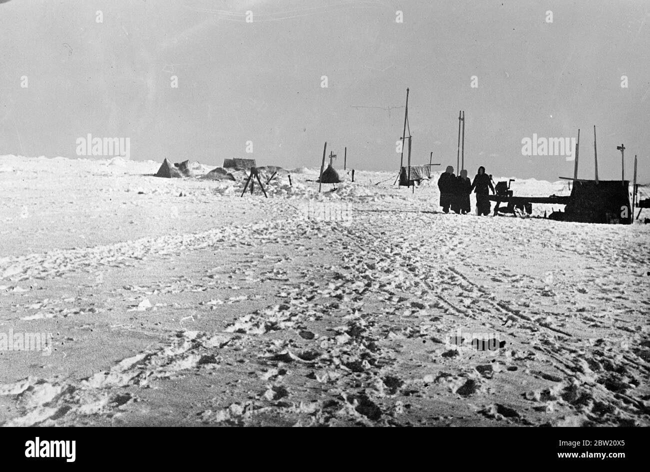These pictures, from the North Pole, were flown to Moscow and from there to London. The Soviet scientific expedition led by Professor Otto Schmidt successfully established a scientific village on an ice floe in the frozen wilderness from which valuable scientific information and regular weather reports are now being sent by radio for the first time in history. A view of the scientist's camp on the ice floe. 30 June 1937 Stock Photo