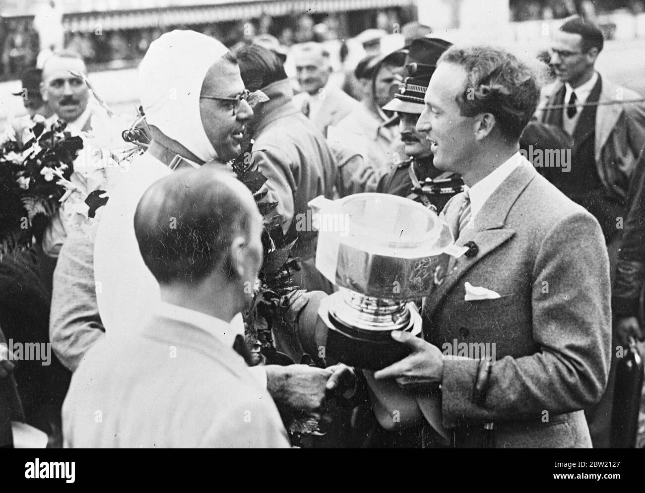 King Leopold of Belgians presented the Cup to the winner, R. Hasse (German Auto Union), after the Speed Grand Prix at Francorchamp [Circuit de Spa-Francorchamp]. 12 July 1937 Stock Photo