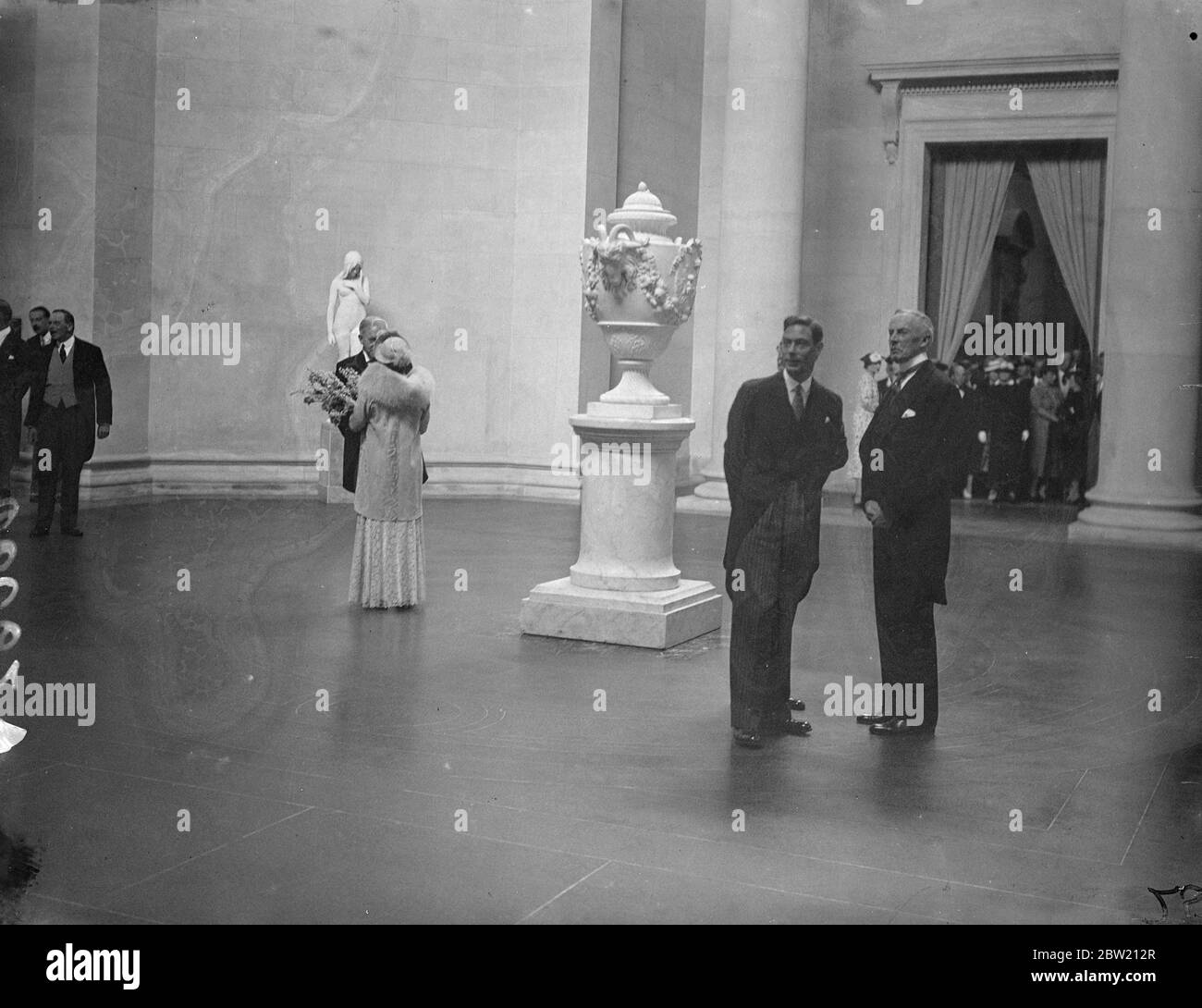 The new Tate Gallery which the King and Queen opened today (Tuesday). The sculpture gallery which was presented by Lord Duveen, gives an architectural vista nearly 500 feet long and is the greatest hall of sculpture in the world. The King a accompanied by Sir Evan Charteris, Chairman of the Tate Gallery viewing the sculpture. 29 June 1937 Stock Photo