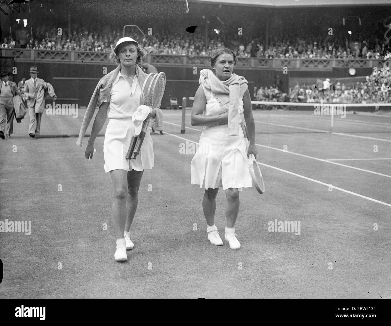 Mme J. Jedrzejowska of Polland and Miss Alice Marble walking off the Centre Court after their match. Mme Jedrzejowska beat Miss Marble, the American women's champion, 8 - 6, 6 - 2, in the semi-final women's singles at Wimbledon. 1 July 1937 Stock Photo