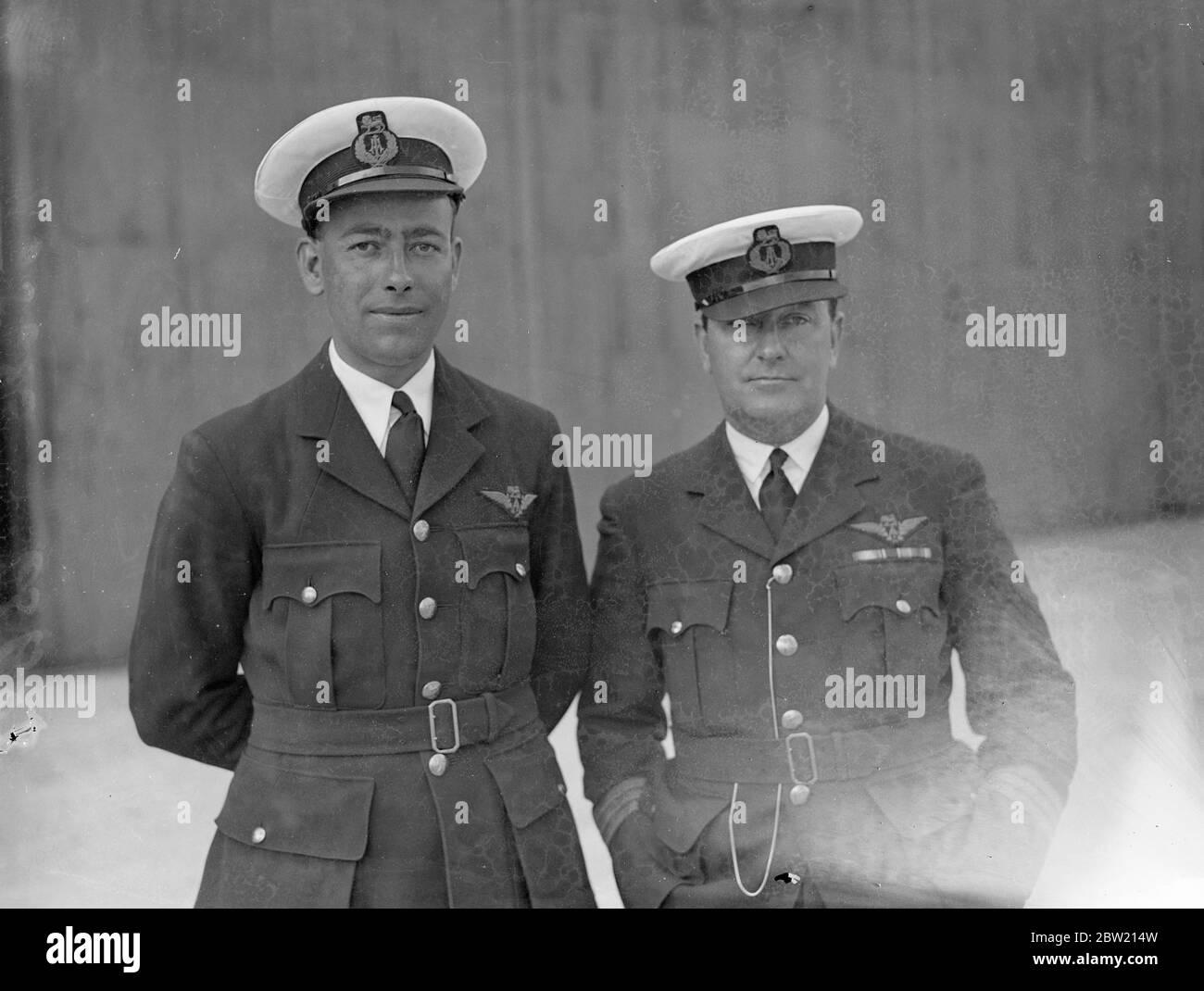 Captain A. S. Wilcockson (right) and First Officer G. H. Bowes at Hythe, Southampton where they have been preparing for the first experimental commercial transatlantic crossing to be made by the flying boat Caledonia next week (June 24). 18 June 1937 Stock Photo