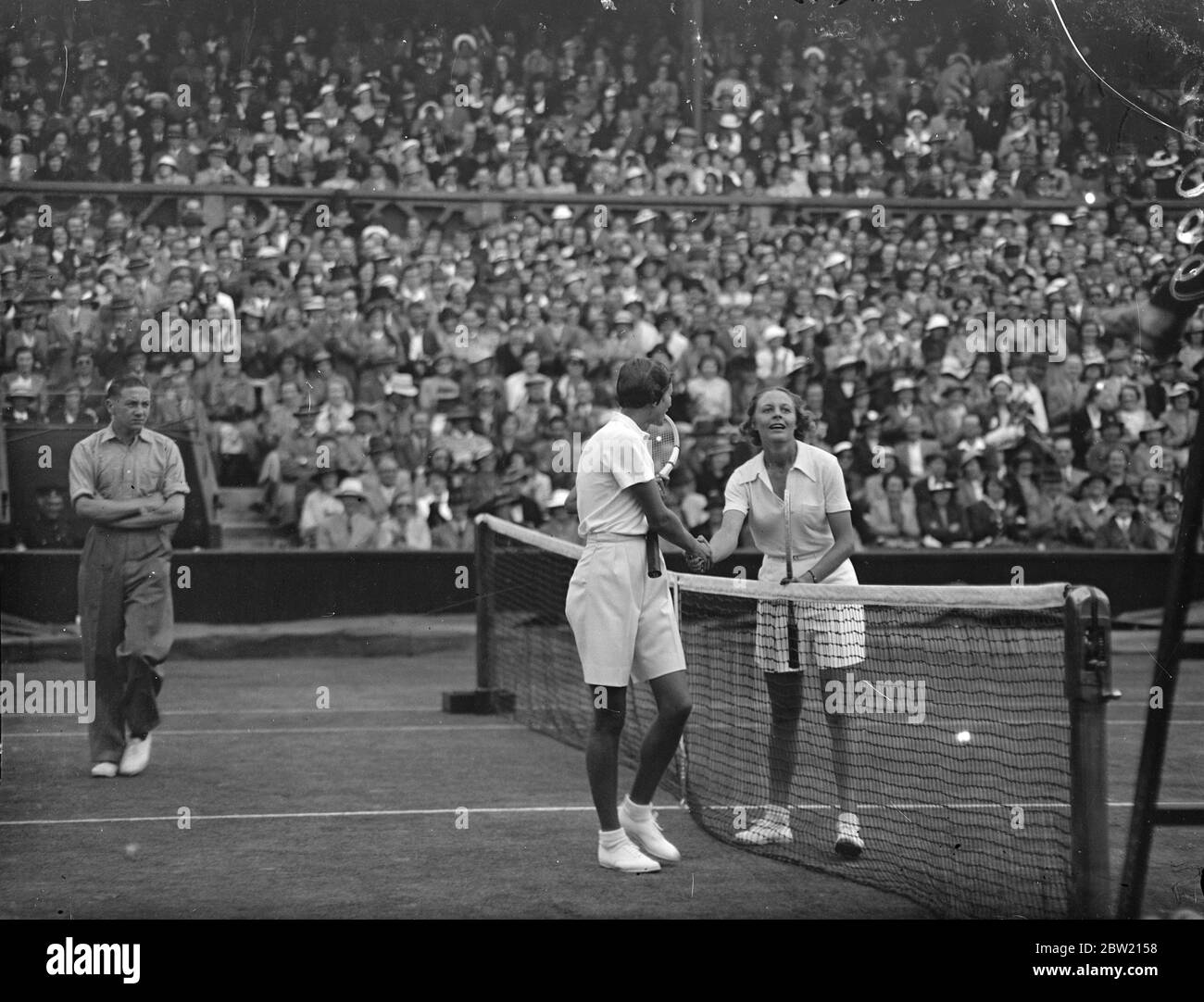 With bewildering speed which baffled her opponent, Miss Alice Marble, the American woman's champion, scored a surprise defeat over Fru Sperling, the Danish favourite for the title, 7 - 5, 2 - 6, 6 - 3, to enter the semifinals of the women's singles at Wimbledon. Alice Marble (right) is congratulated by Fru Sperling after her victory 29 June 1937 Stock Photo