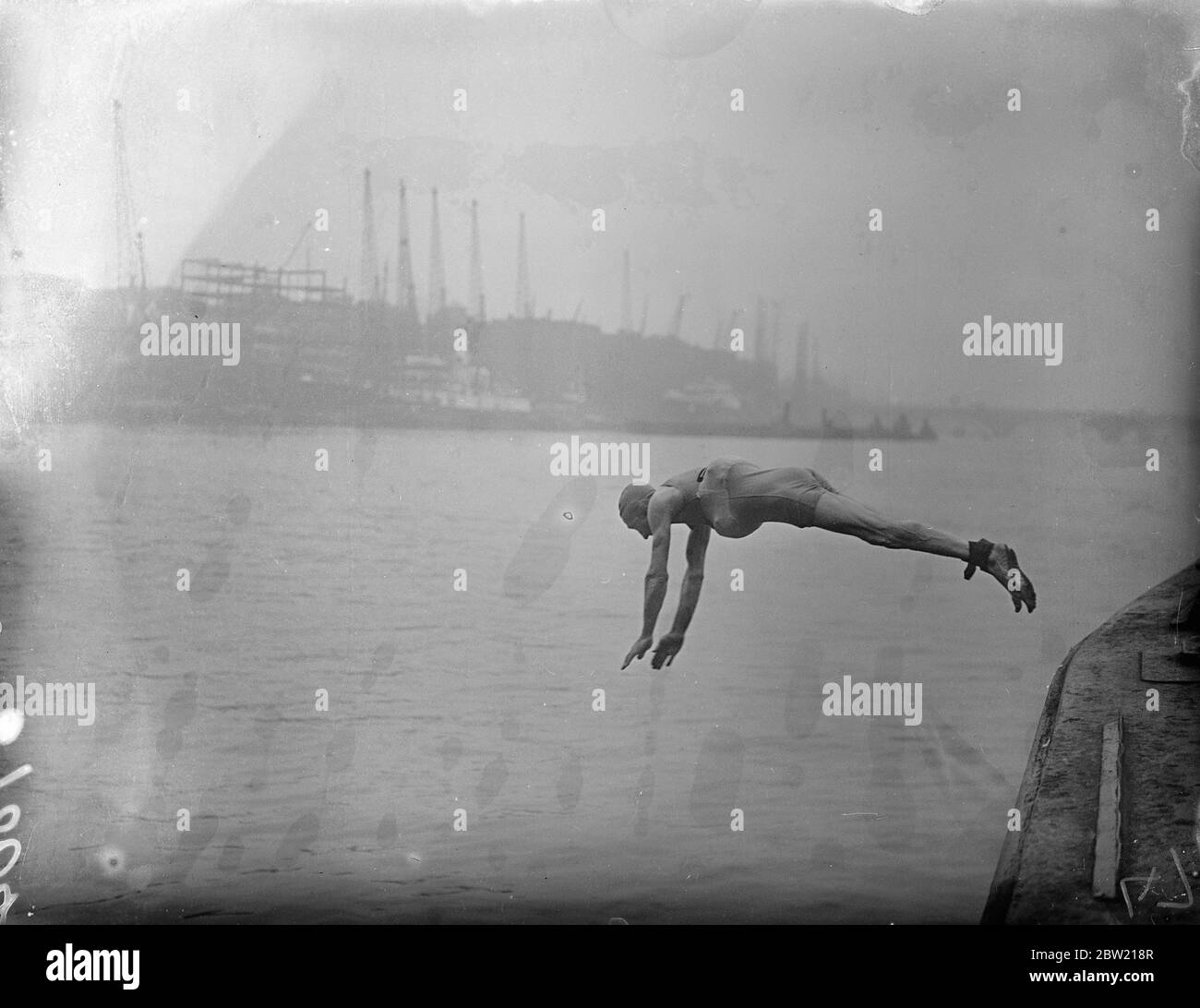 With his ankles strapped, Mr Frederick William Slade jumped into the Thames at Tower Bridge on Sunday morning to demonstrate his new Safety Bathing Costume. The costume is fitted back and front with pockets in which air floats are held by zip fasteners. The floats can be easily taken out and the costume worn in the ordinary way for sunbathing. 29 August 1937 Stock Photo