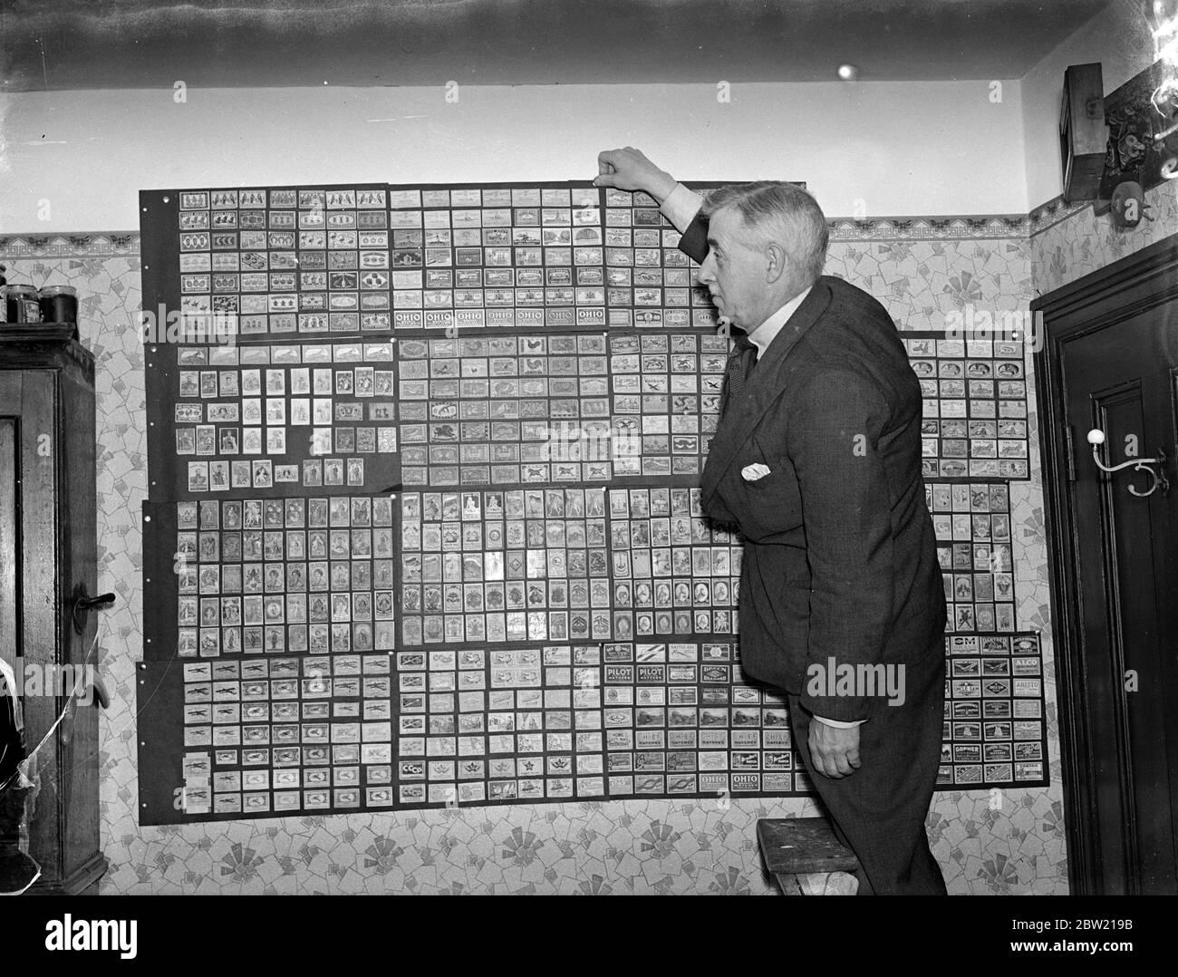 Mr S H Toole with some of his rare matchbox labels at his Southampton home will stop he has collected 15,000 matchbox labels in this 16 years since he commenced his curious hobby in 1921. He is now planning to hold an exhibition of match box-label collections in London. 13 August 1937. Stock Photo